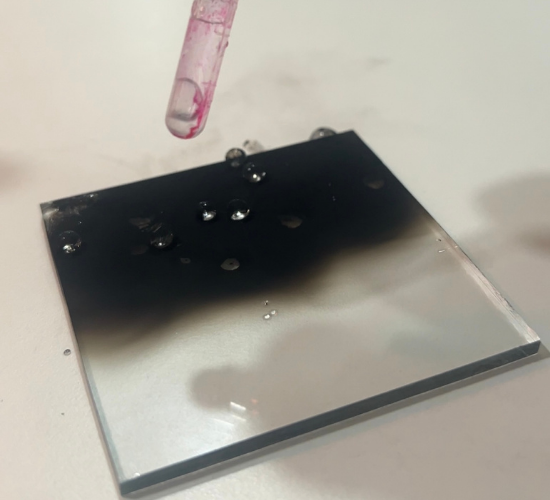 Dancing Water on Sooty Glass